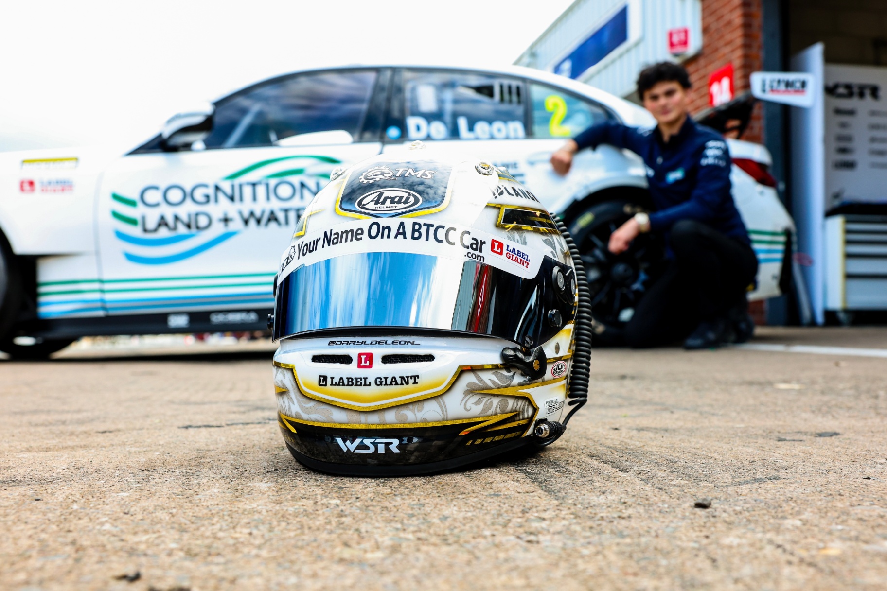 Helmet on the ground with BTCC car in the background
