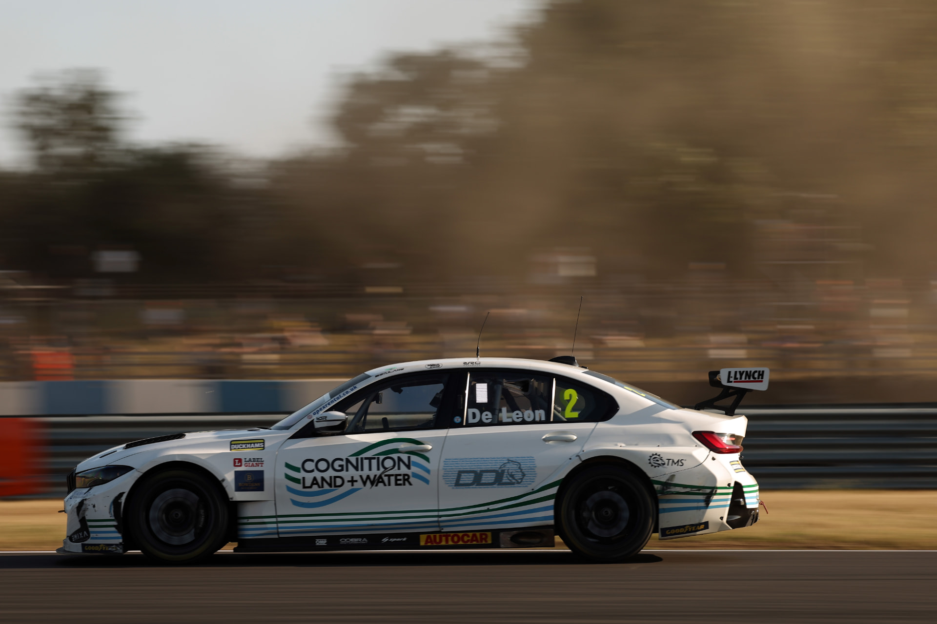 The #2 De Leon BTCC car at speed in golden evening light